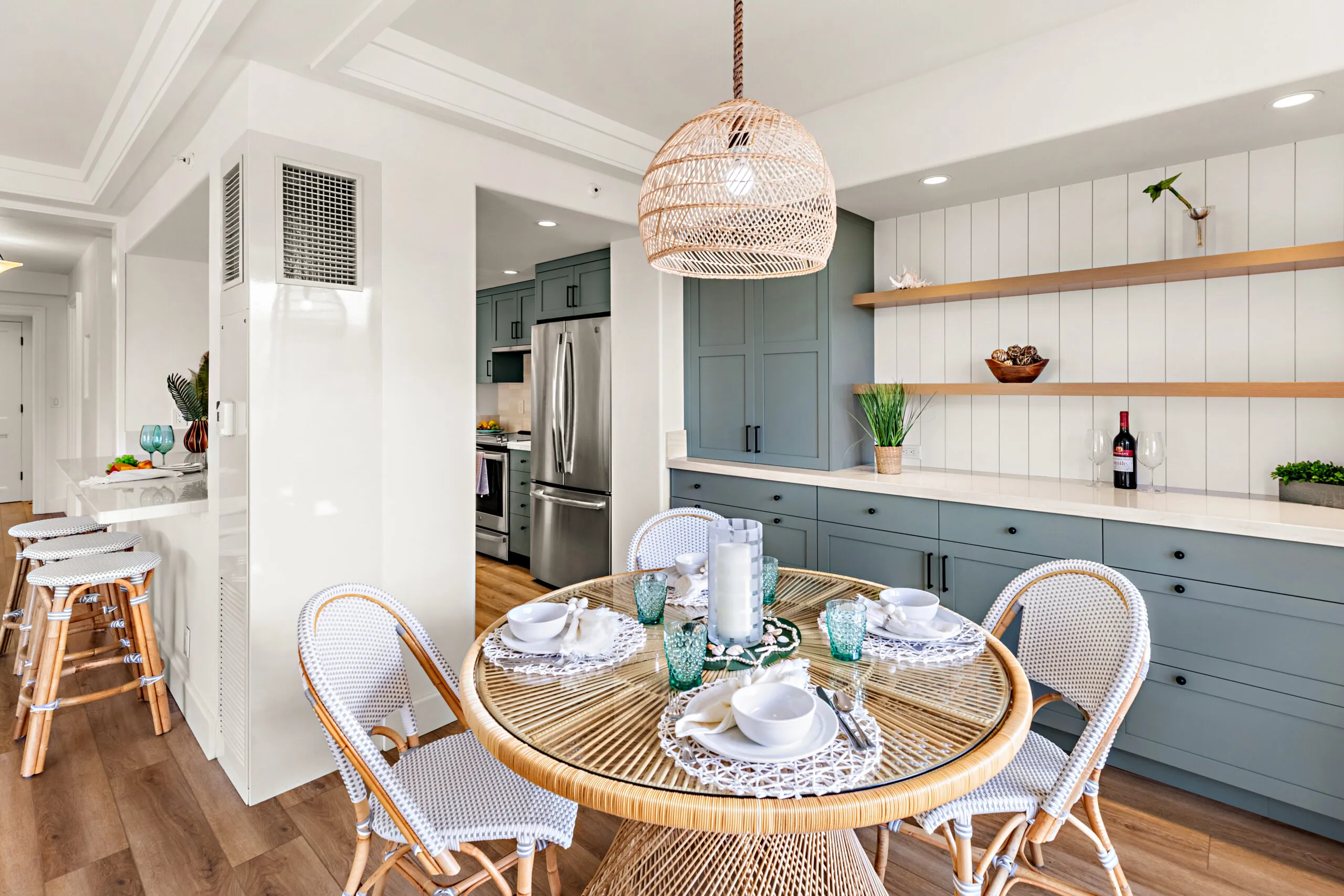Cozy dining area with a round table set for four and a pendant light above.