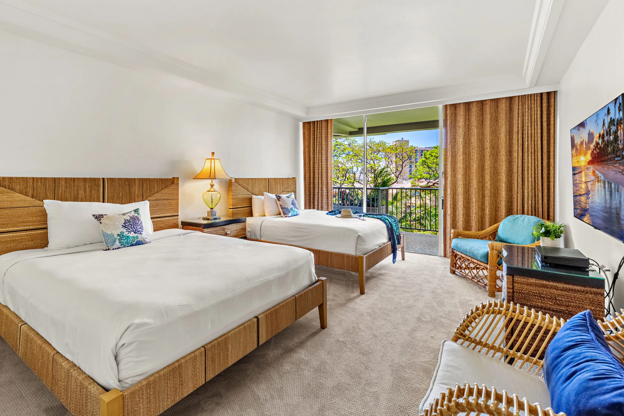 Bright bedroom with two beds and a private balcony.