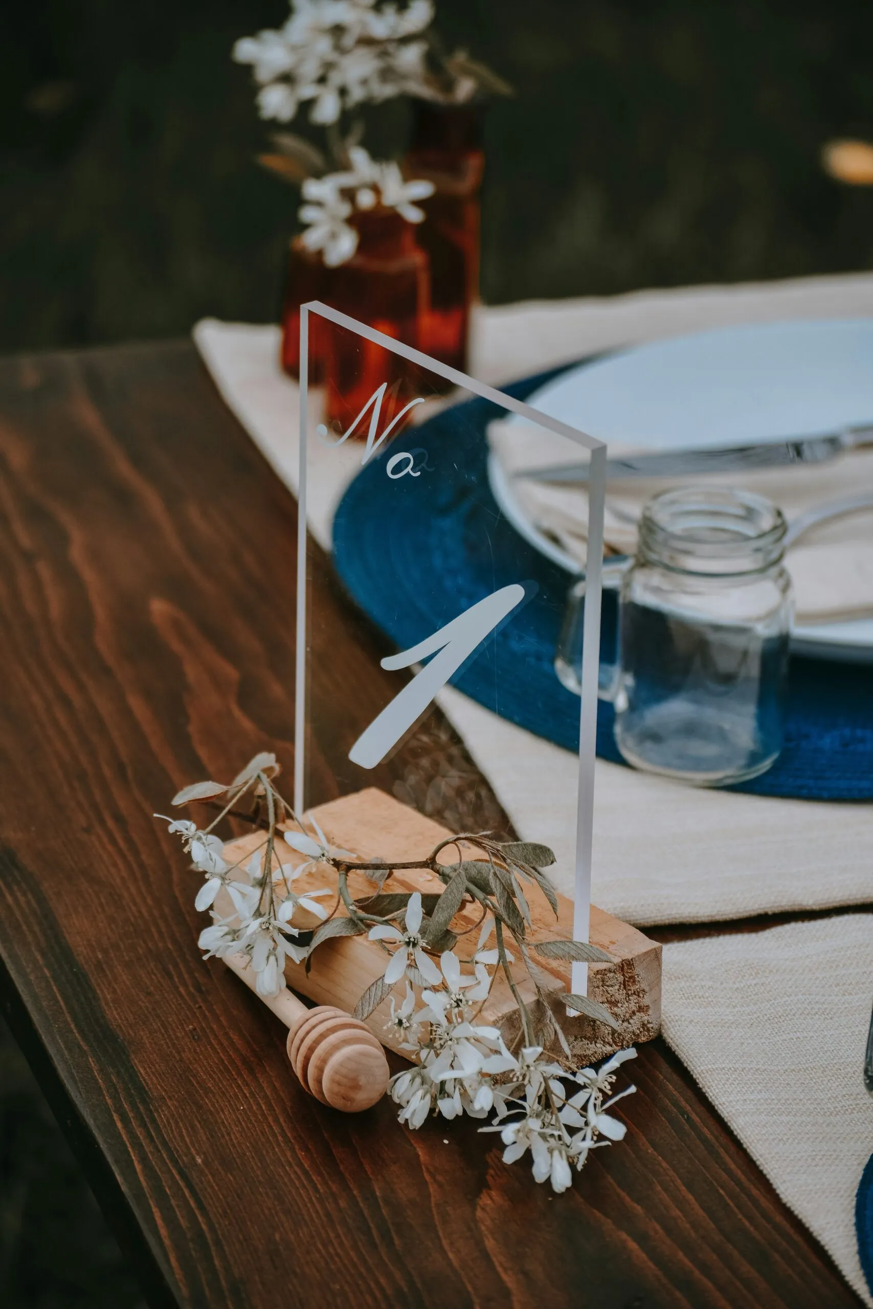 Wedding table setting with table number and flowers.